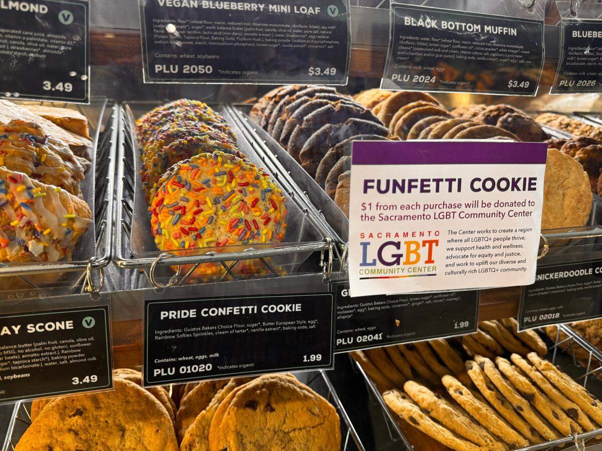 A tray of cookies baked with rainbow sprinkles sits in a pastry stand at Sacramento Natural Foods Co-op on Wednesday, June 17, 2025. For every funfetti cookie purchased, $1 will be donated to the Sacramento LGBT Community Center.