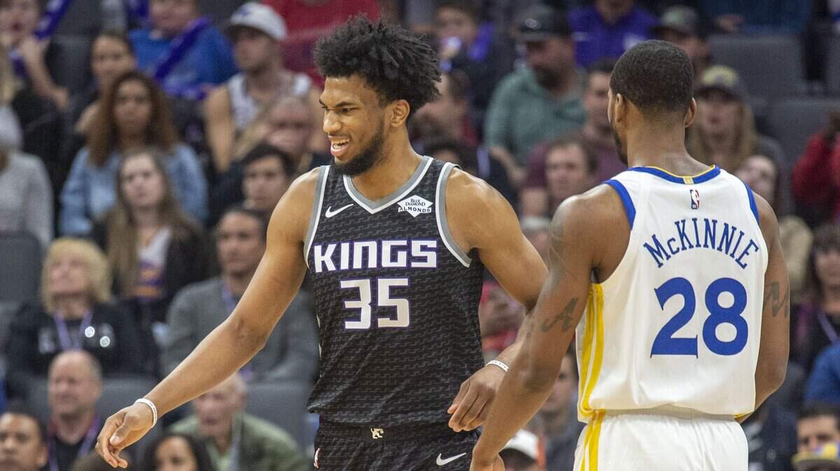 Kings forward Marvin Bagley III (35) grimaces after injuring his left knee against the Warriors on Friday night, Dec. 14, 2018, at Golden 1 Center. An MRI revealed a bone bruise. He’ll be reevaluated in 10-14 days, the team said.