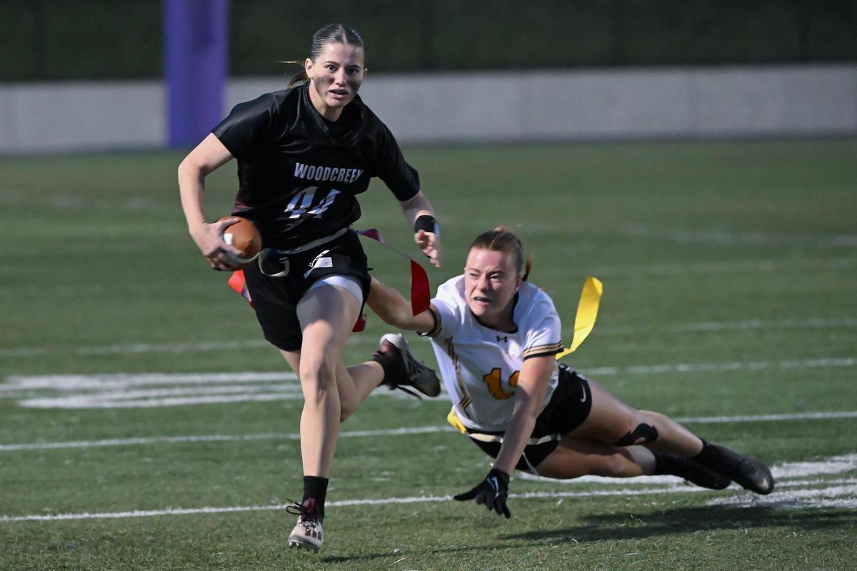 The Del Oro Golden Eagles’ Izzy Scott (13) dives in an attempt to pull the flag of Woodcreek Timberwolves quarterback Izzy Deveraux (44) in the first half of the CIF Sac-Joaquin Division I flag football championship on Saturday, Nov. 4, 2023, at Cosumnes River College in Sacramento.