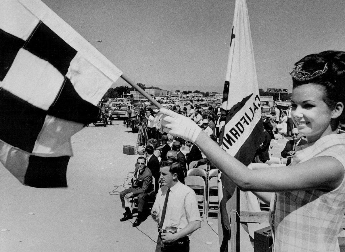 A starting flag is waved by Miss Sacramento Patti Smith to start traffic through the interchange connecting the W-X segment of Highway 50 to the freeway that runs between 29th and 30th streets during the official dedication ceremonies on June 25, 1968.