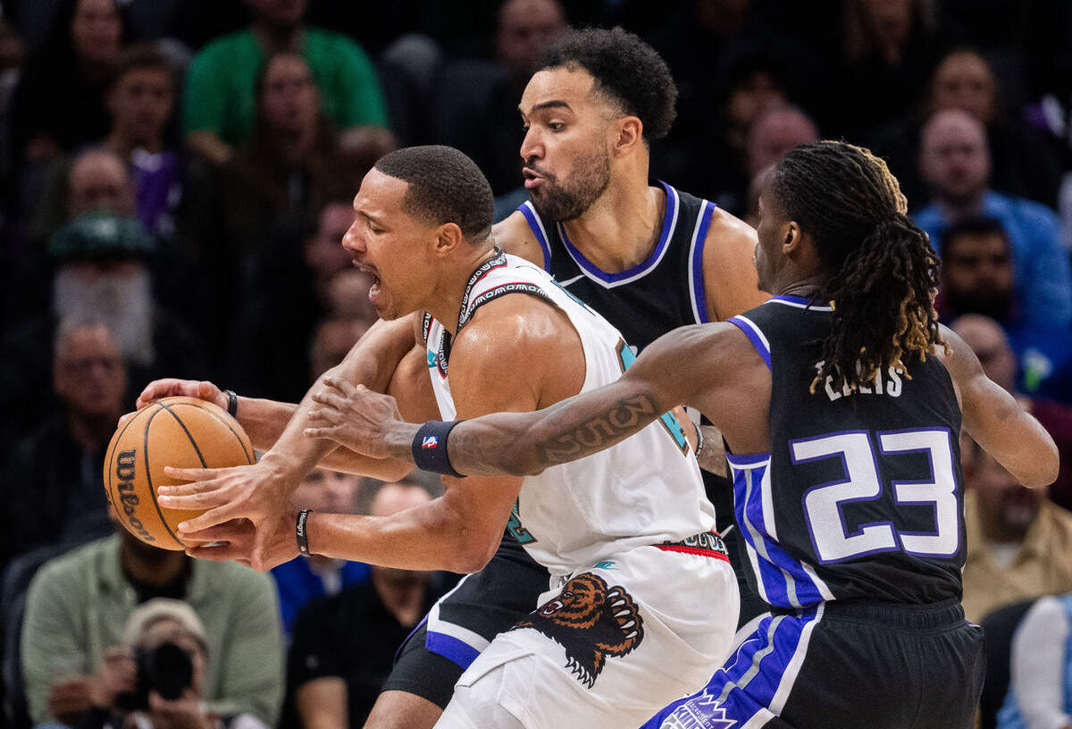Memphis Grizzlies guard Desmond Bane (22) fights for the ball as he’s defended by Sacramento Kings forward Trey Lyles (41) and teammate Keon Ellis (23) during an NBA game on Monday, March 17, 2025 at Golden 1 Center. Bane lost the ball on a travel call.