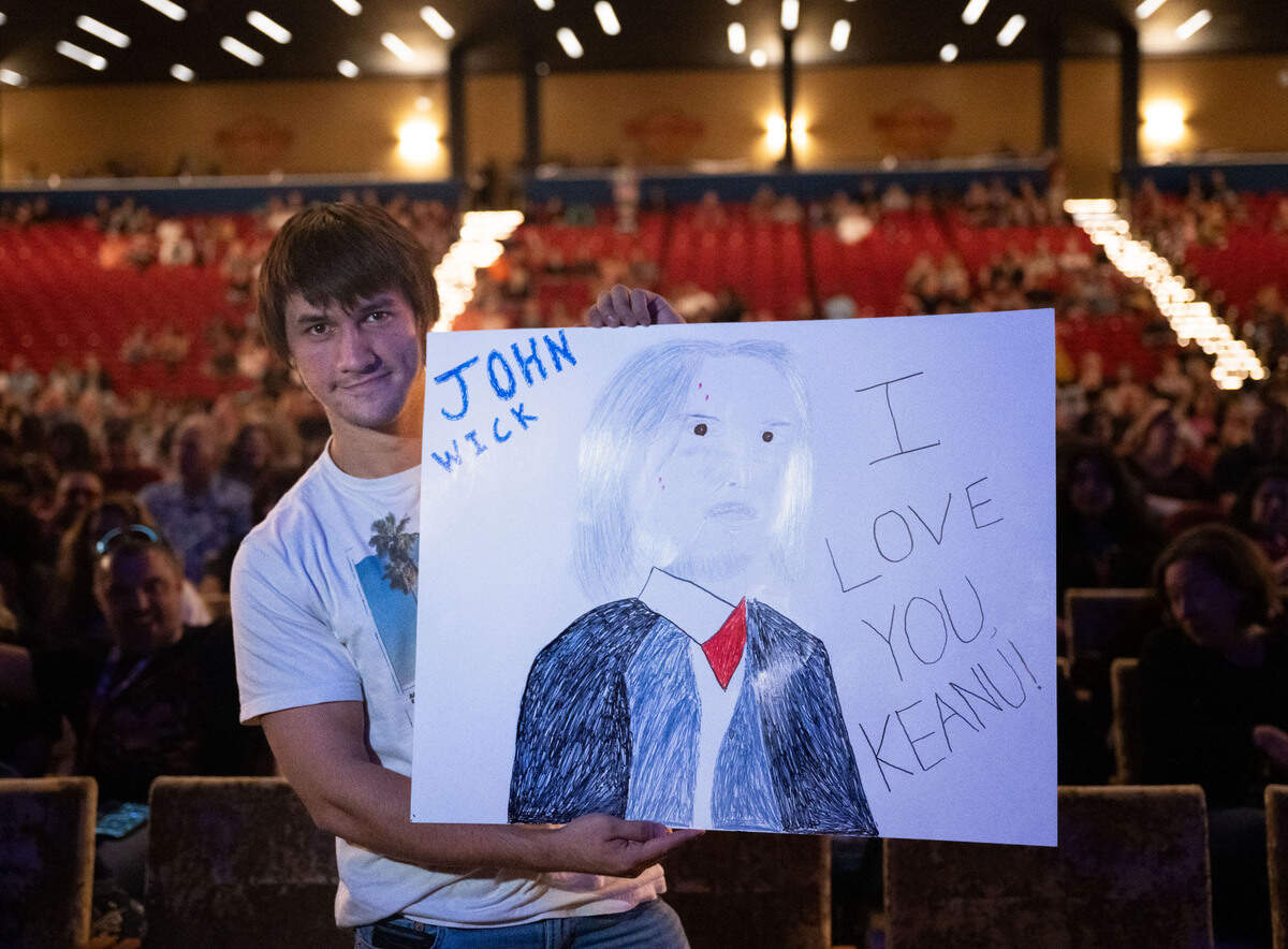 Dylan Oyanguren holds up a poster-sized drawing of Keanu Reeves in the role of “John Wick” before the movie star took the stage with his band Dogstar at the Hard Rock Live Sacramento near Wheatland on Saturday, Sept. 14, 2024.