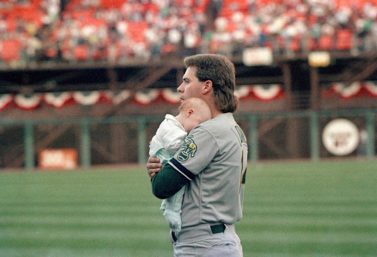 Oakland Athletics pitcher Storm Davis holds his baby daughter Erin on the field at Candlestick Park after the Loma Prieta earthquake struck during Game 3 of the World Series on Oct. 17, 1989. Davis’ daughter had been in the stands prior to the quake and was handed to him after the quake struck.