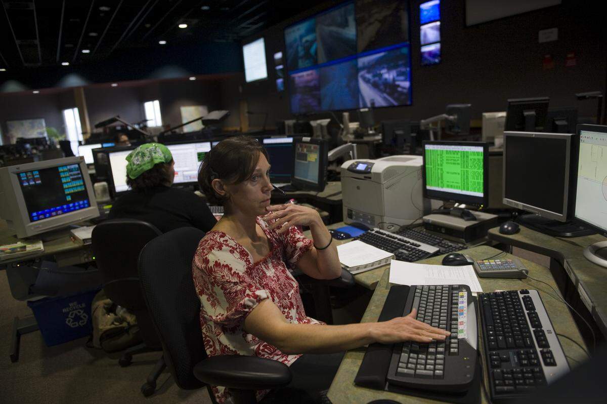 Julie Cunningham, a public safety dispatcher, listens intently to a call while working at the CHP 911 dispatch center in Rancho Cordova in 2009.
