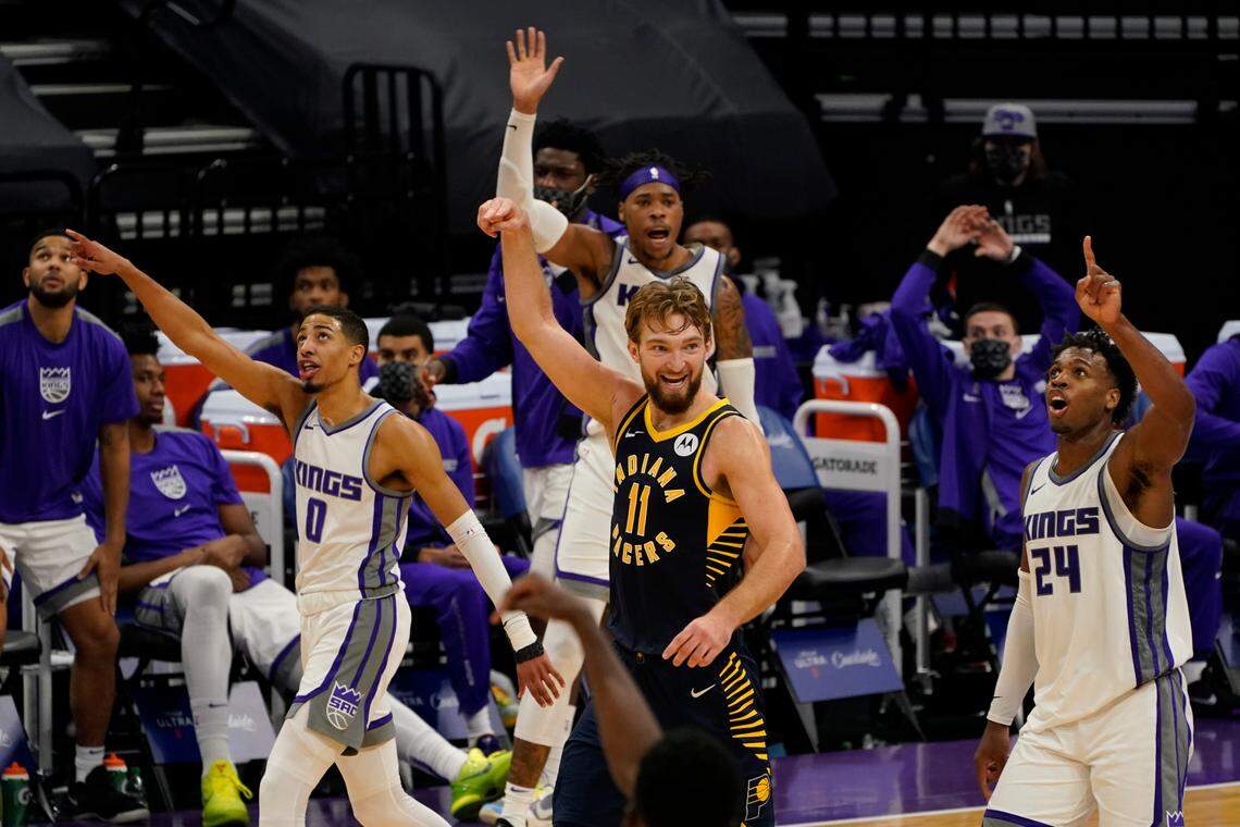Indiana Pacers forward Domantas Sabonis, center, signals for a basket as Sacramento Kings’ Tyrese Haliburton, left, Richaun Holmes, background center, and Buddy Hield, right, ask for a review of the goal tending call against Holmes during the second half of an NBA basketball game in Sacramento, Calif., Monday, Jan. 11, 2021. After a review and the call was reversed. The Kings won 127-122. (AP Photo/Rich Pedroncelli)