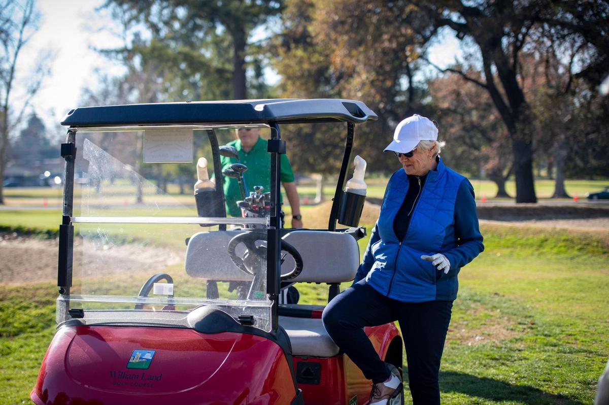 Deanna Vattuone steps into a golf cart at the William Land Golf Course in December as her husband, Armand, approaches. The 9-hole course in the center of Land Park is the oldest venue in Sacramento County.