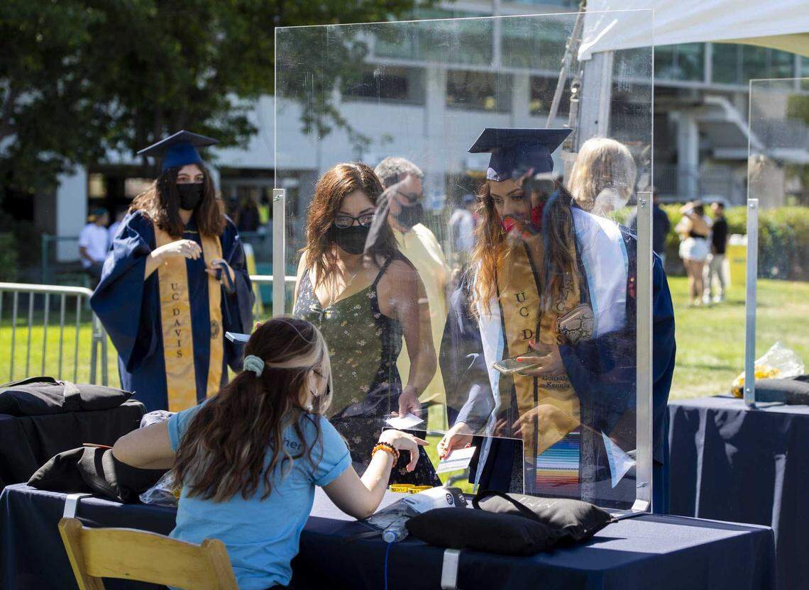 UC Davis students and family show either proof of vaccination or a negative COVID-19 test at a screening station before entering the University Credit Union Center for graduation ceremonies on June 11, 2021.