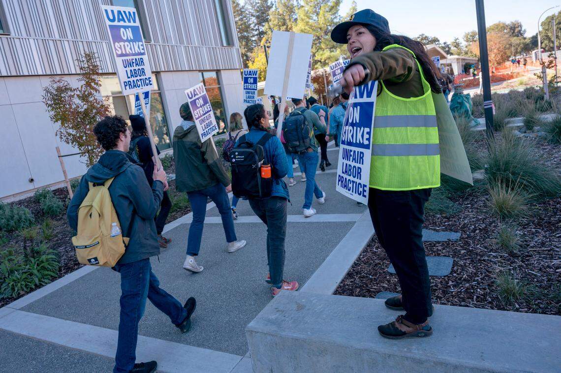 UC Davis grad student Ximena Able Gil, right, directs students as they strike on campus on Monday, Nov. 14, 2022. Academic workers across the University of California system walked off the job after contract negotiations broke down.