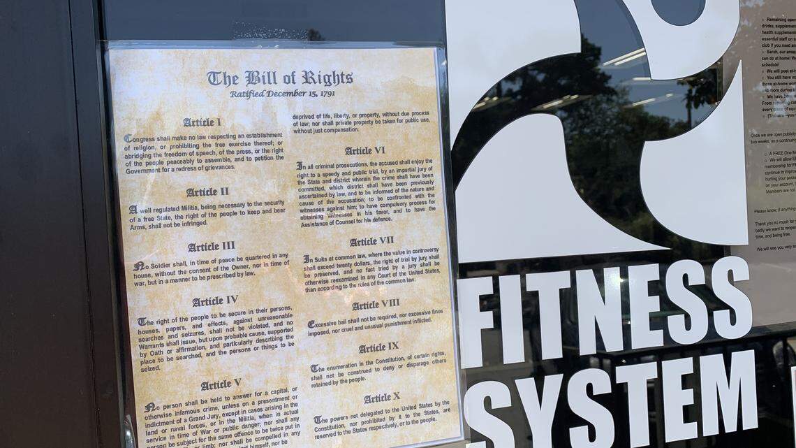 The front entrance at Fitness System’s health club in Sacramento, with a copy of the Bill of Rights taped to the door. A federal judge dismissed a lawsuit Tuesday, Oct. 27, 2020, that the owner had filed against California Gov. Gavin Newsom and other officials because of COVID-19 shutdowns. 
