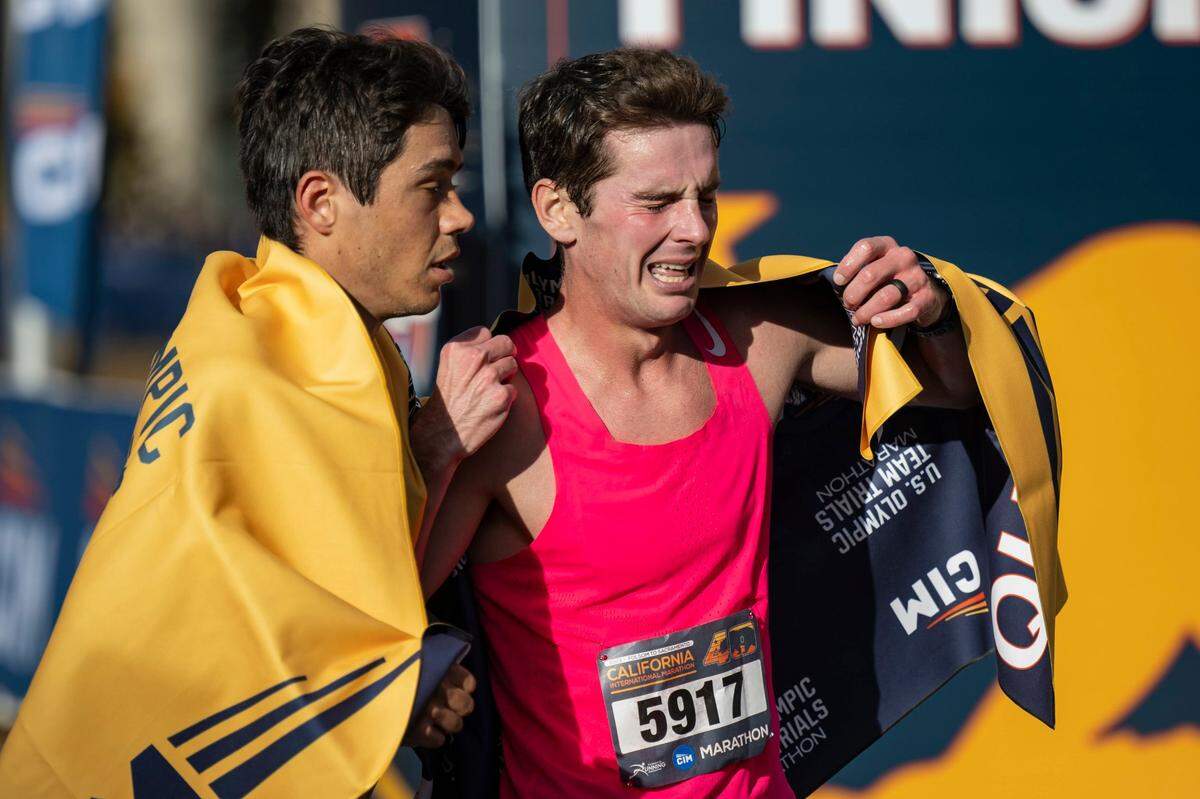 Robert Miranda, left, of Venice, Calif., hugs Jerod Broadbooks, of O’Fallon, Mo., at the finish line in the 40th California International Marathon from Folsom to the state Capitol in downtown Sacramento, on Sunday, Dec. 3, 2023.