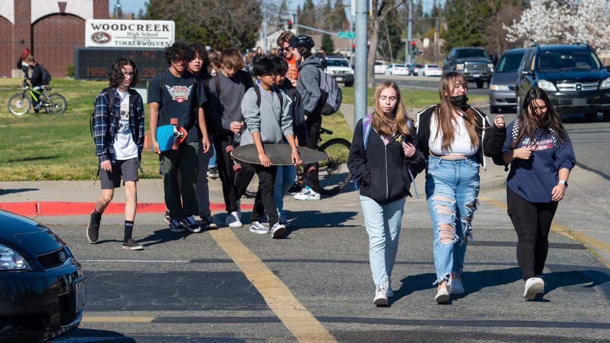 Students exit Woodcreek High School at the end of the school day on March 7 in Roseville. The Roseville Joint Unified High School District voted in February to stop enforcing the statewide health order requiring masking in schools, well before the state lifted the its school mask mandate on March 12.