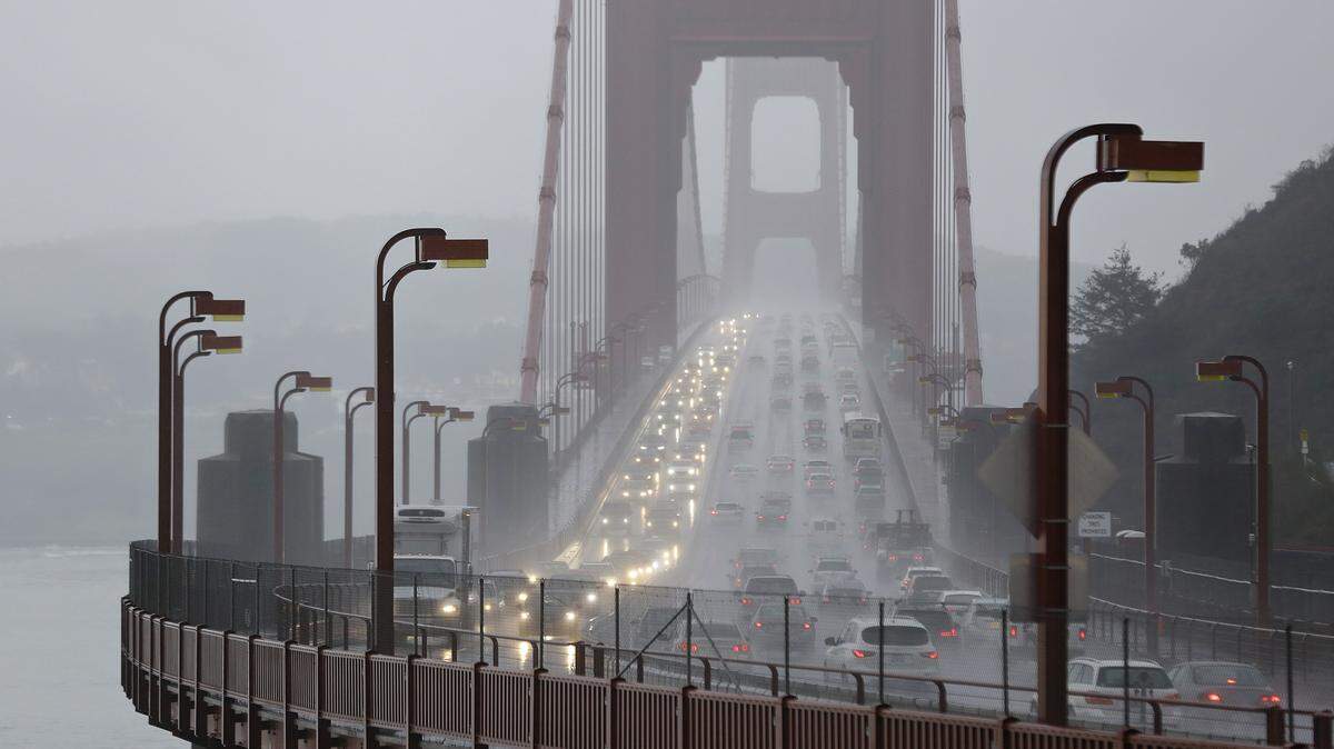 FILE - In this Jan. 5, 2016, file photo, traffic crosses the Golden Gate Bridge in the rain in this view from Sausalito, Calif. Northern California’s iconic Golden Gate Bridge will cost southbound motorists and additional quarter to cross starting July 1, 2018. The Marin Independent Journal reported Saturday, May 19, 2018, that the toll hike will mean some drivers will pay as much as $8 to travel from Marin County to San Francisco. (AP Photo/Eric Risberg)