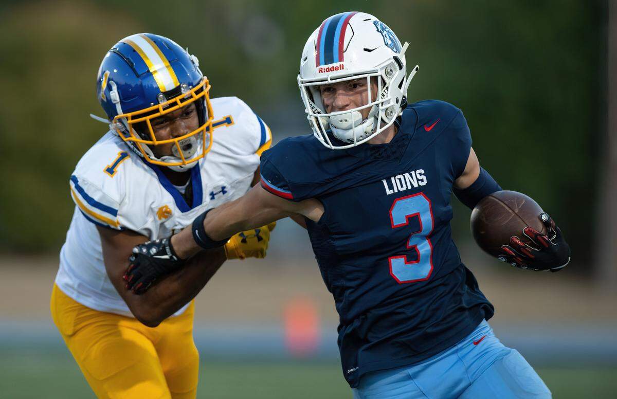 The Destiny Christian Lions’ Greyson Smith (3) attempts to evade the Linden Lions’ DeAndre Smith (1) as he returns an interception on Sept. 6 in Rosemont.