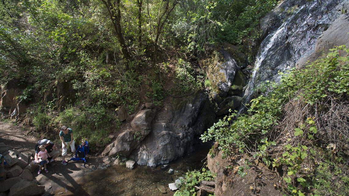 Jeff and Abigail Hakala, with their three children, check out a waterfall on Canyon Creek along the Western States Trail on Tuesday, April 26, 2016 in Auburn, Calif.