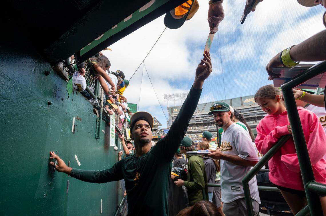 The Oakland A’s Darell Hernaiz signs autographs before the last home game at Oakland-Alameda County Coliseum on Thursday in Oakland.