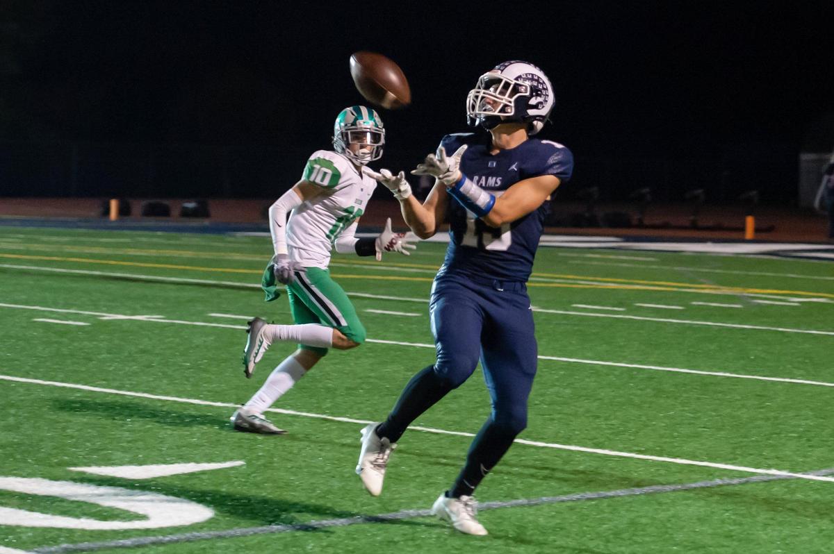 Casa Roble Rams Logan March (19) catches the ball for a 51 yard gain with Dixon Rams Brent Green (10) on defense during the second quarter in the game Friday at Casa Roble High School in Orangevale.