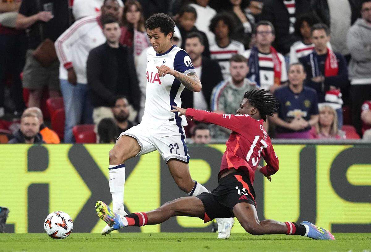 Tottenham Hotspur’s Brennan Johnson, left, works around Manchester United’s Patrick Dorgu during the UEFA Europa League final Wednesday in Spain.