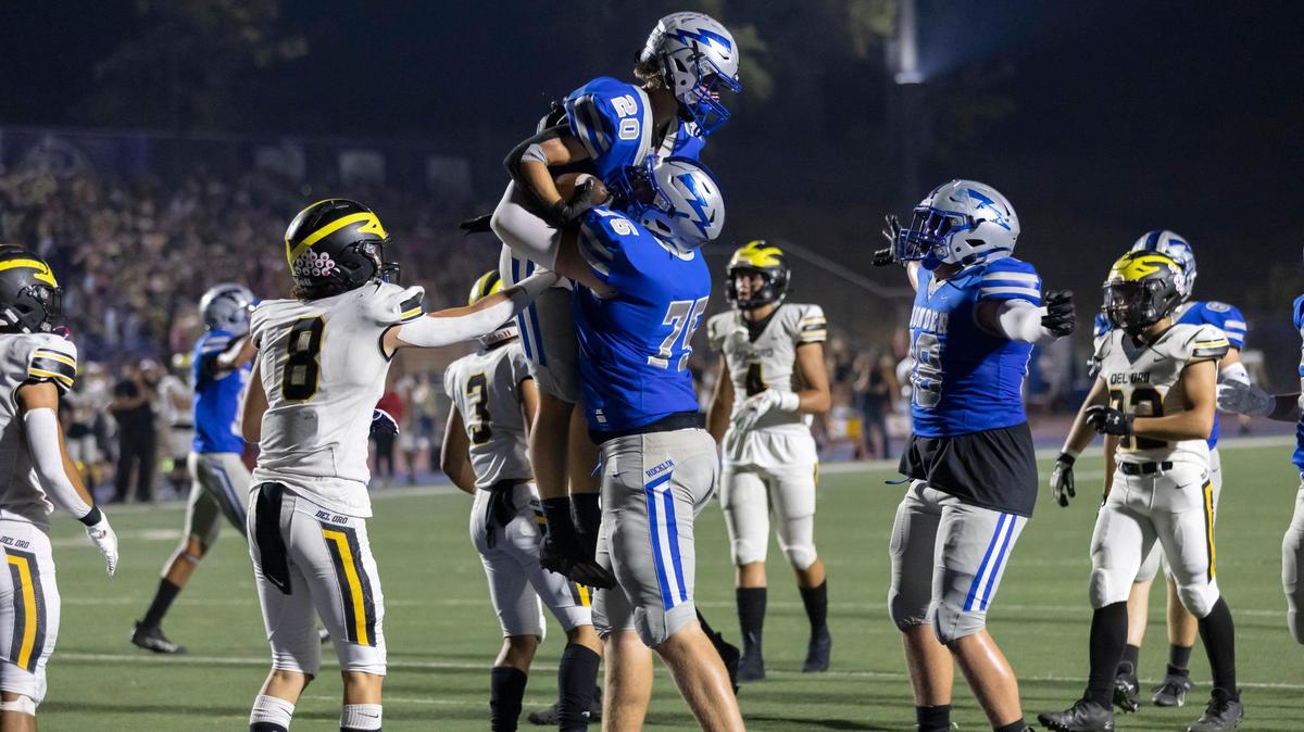 Rocklin’s Brad Baur picks up running back Eli Hardy after he scored a touchdown during the first quarter in the game at Rocklin High School in Rocklin on Friday, Sept. 24, 2021. The Thunder won 38-3.
