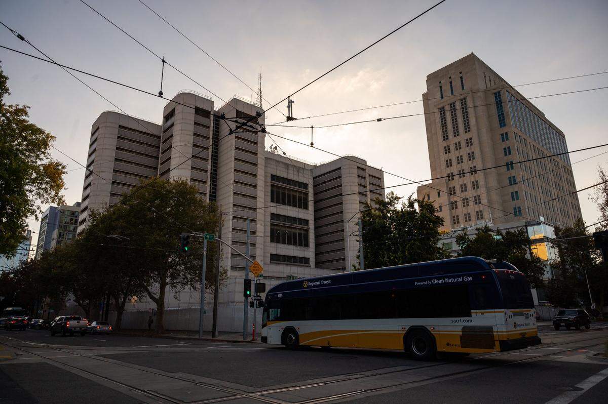A bus passes under Sacramento Regional Transit lines behind the Sacramento County Main Jail at H and 7th streets in downtown Sacramento.