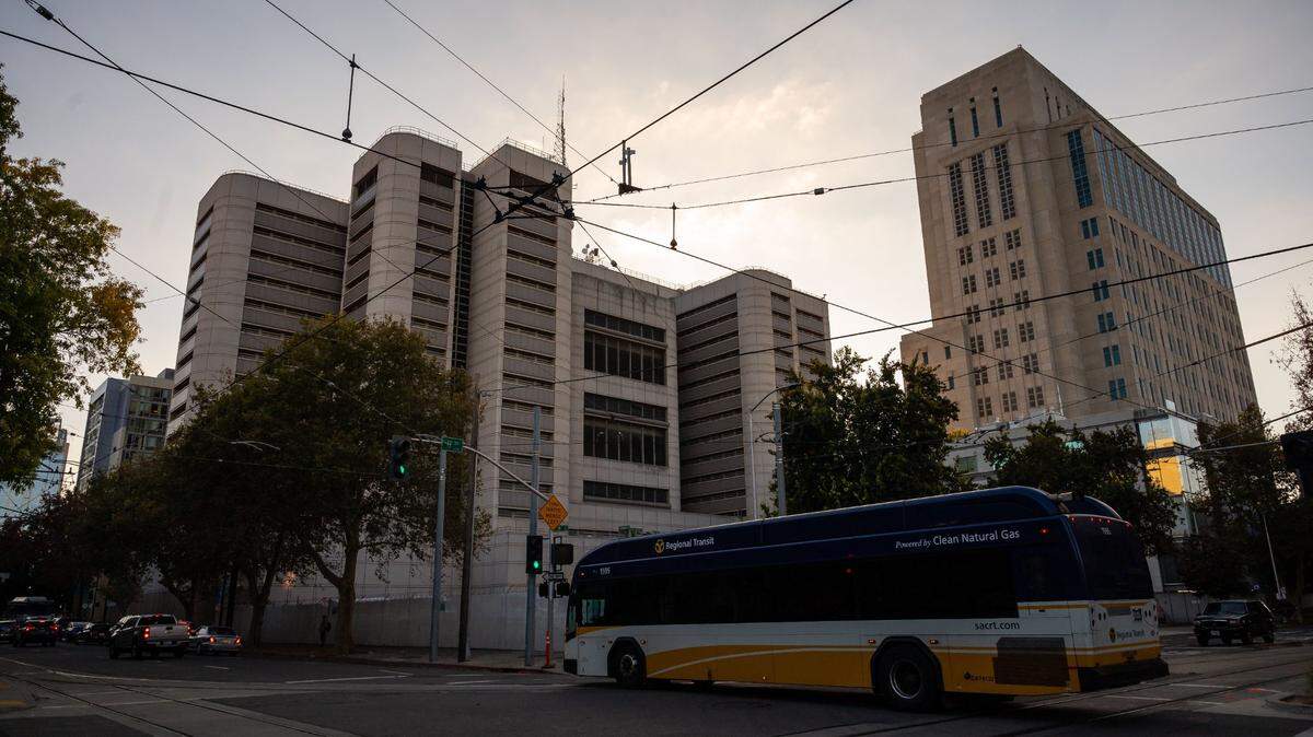 A bus passes by under Sacramento Regional Transit lines behind the Sacramento County Main Jail at H and 7th streets Tuesday, Nov. 2, 2021, in downtown Sacramento.