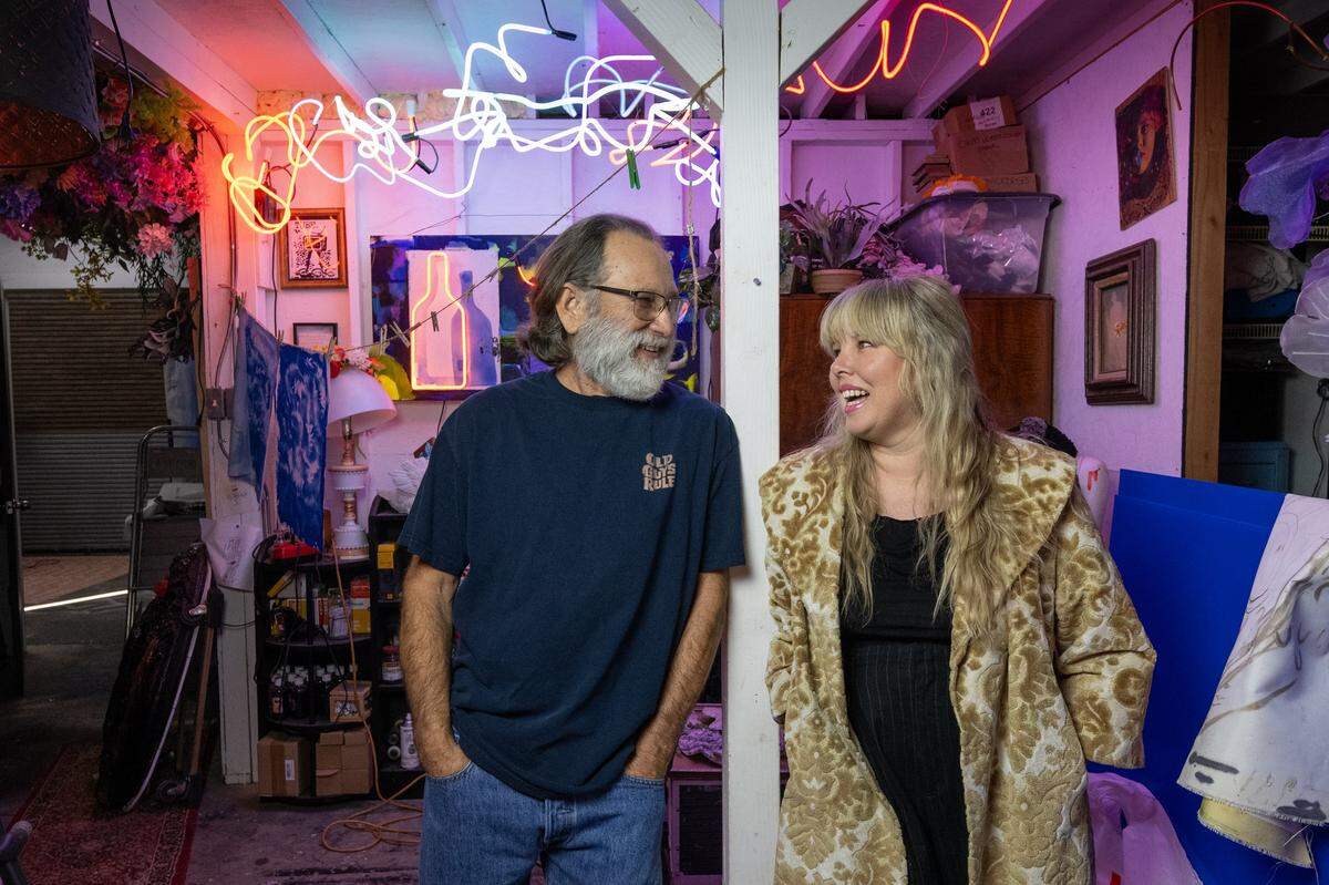 Steve Uroff and his daughter Melissa Uroff, both neon sign artists, stand in her Sacramento studio on Tuesday.
