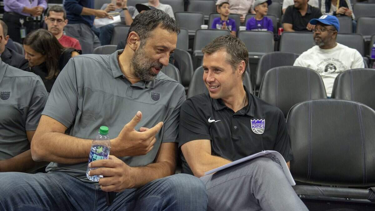 Kings coach Dave Joerger, right, said Monday he was not taking shots at general manager Vlade Divac or the front office with his complimentary words Sunday about Dallas Mavericks rookie Luka Doncic.