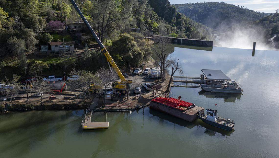 Crews work on cleaning debris that blocked and trapped large logs at Englebright Lake on Tuesday, March 3, 2026, following the large pipe rupture at the New Colgate Powerhouse.
