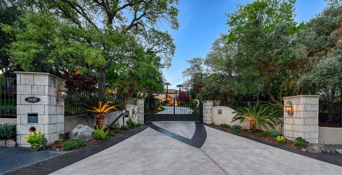 A gated entrance leads to the Loomis home, which sits of five acres.