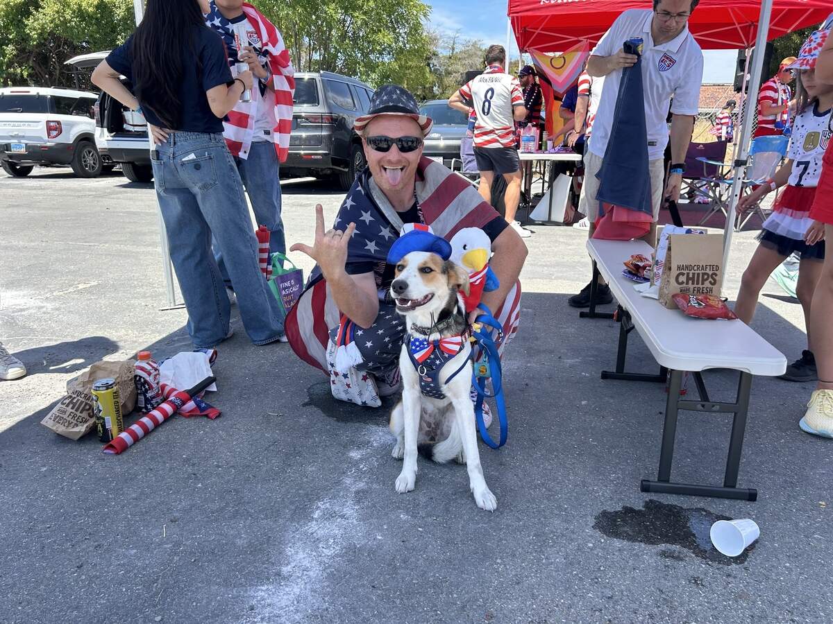 Dan Nicholson and his dog Willow pose for a photo during a parking lot tailgate party in Santa Clara before the U.S. men’s national team plays Bosnia and Herzegovina in a World Cup Round of 32 elimination game Wednesday at Levi’s Stadium.