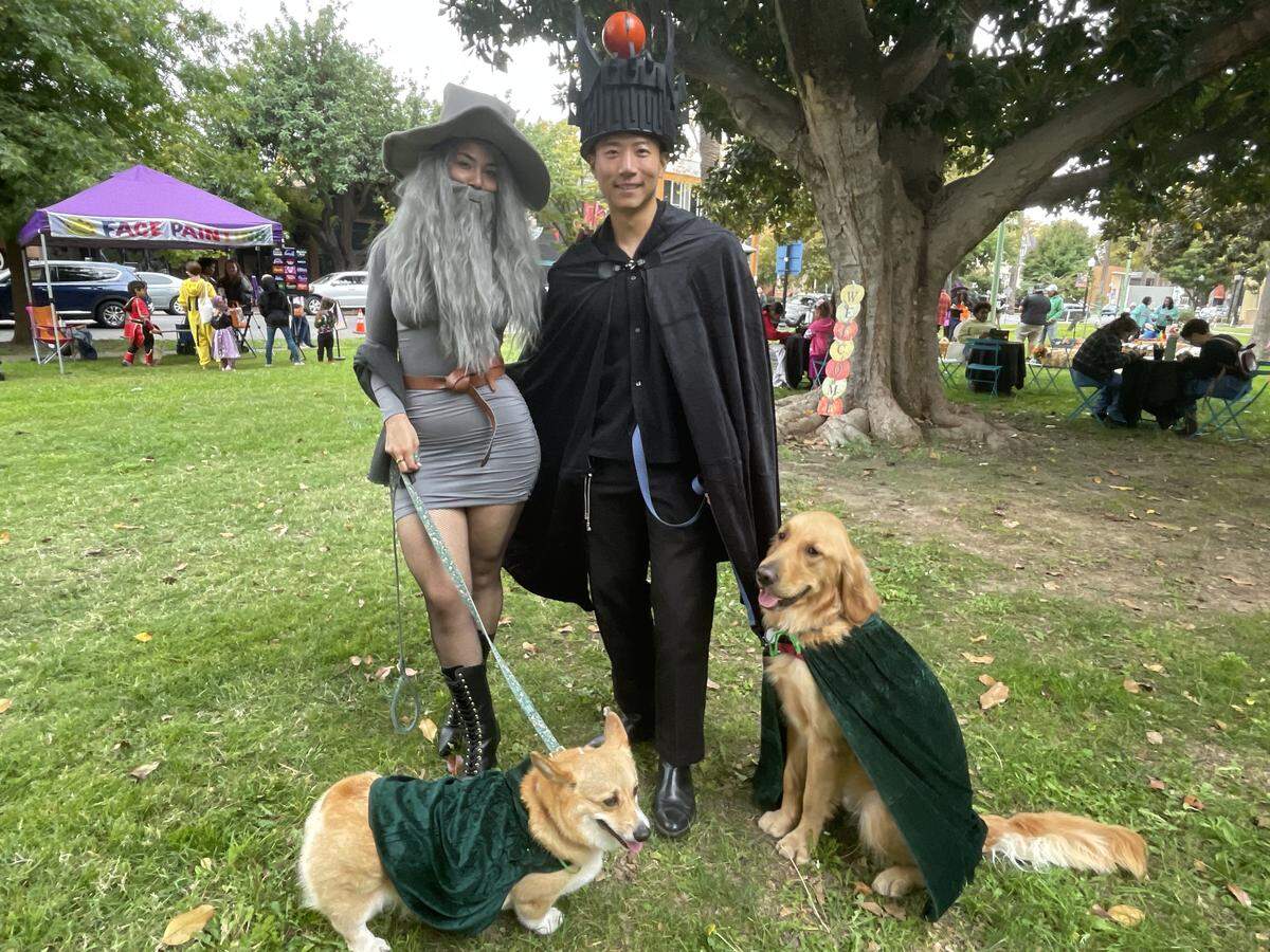 Stephanie Murillo and Jay Jung with their dogs, Summer and Cosmo, on Oct. 25, 2025. The two, who were dressed as Gandalf and Sauron from “Lord of the Rings,” dressed their dogs as hobbits for the Pooch Parade.