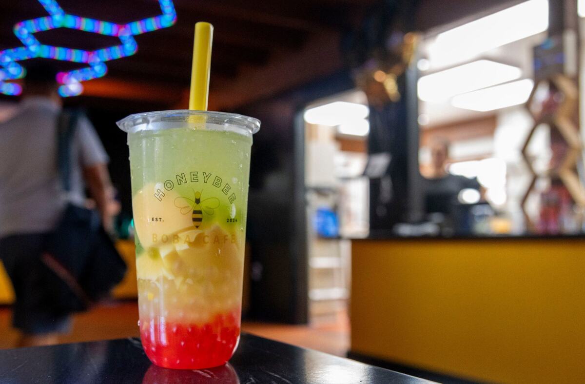 A honeydew flavored fruit tea drink with boba toppings is self-served at Honeybee Boba Cafe in East Sacramento on Wednesday.