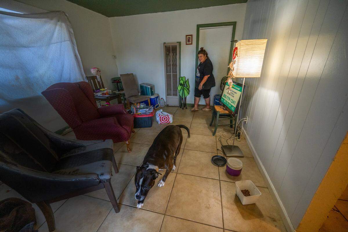Tammy Myler, 57, a former Camp Resolution resident, now lives with her dog, Panic, in her $1,200-a-month Sacramento apartment in October. She said that when she moved in, the apartment was filthy, with brown walls and a rat infestation that destroyed the stove insulation, leaving it unusable.
