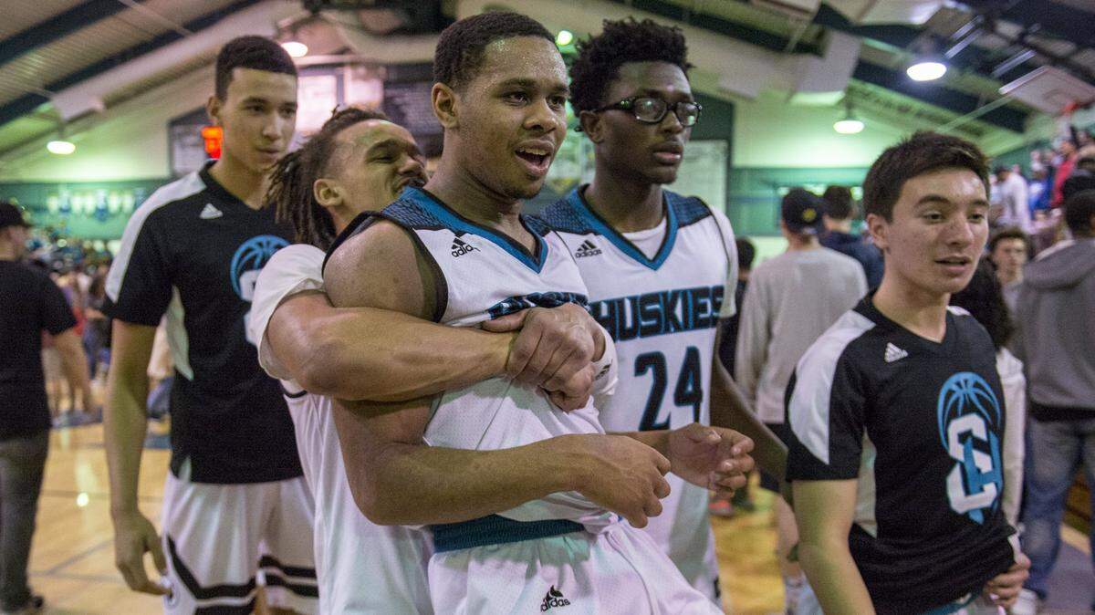 Sheldon Huskies guard Dale Currie (0) embraces teammate Dom Johnson (1) after the Huskies made up a double midget halftime deficit to beat the Panthers 67-65 as the Sheldon Huskies hosted the San San Joaquin Memorial Panthers in the first round of the NorCal open division on Friday March 9, 2018 at Sheldon High School.