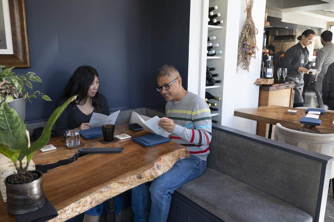 Stephanie and Jason Buzon look over menus during Localis’ return of brunch service at their restaurant in Sacramento on Sunday, Feb. 22, 2026.