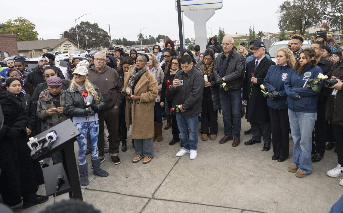 Community members mourn at a vigil in Stockton on Sunday for the four people killed and 11 injured in a mass shooting the night before. 