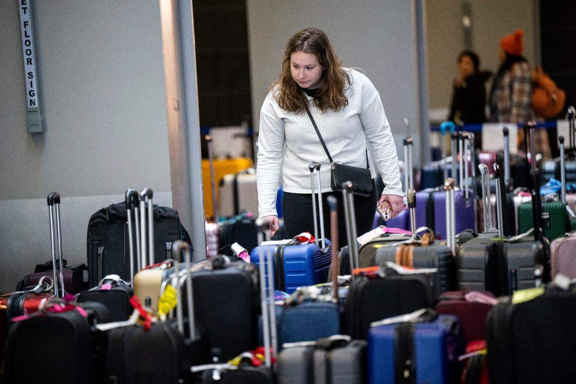 Sophie Parsh of San Diego looks for her bags on Thursday, Dec. 29, 2022, that went missing after she was traveling to Sacramento from Denver on Southwest. Parsh, who is visiting her mother, was among the customers who arrived at Sacramento International Airport’s Terminal B to find their bags missing.