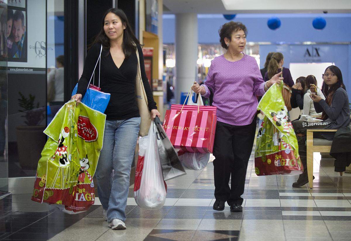 Sabrina Ko of Elk Grove, left, and her mother Betsy Ng of Land Park head to their car following a busy morning of shopping for Christmas gifts at Arden Fair mall on Nov. 27, 2009. 