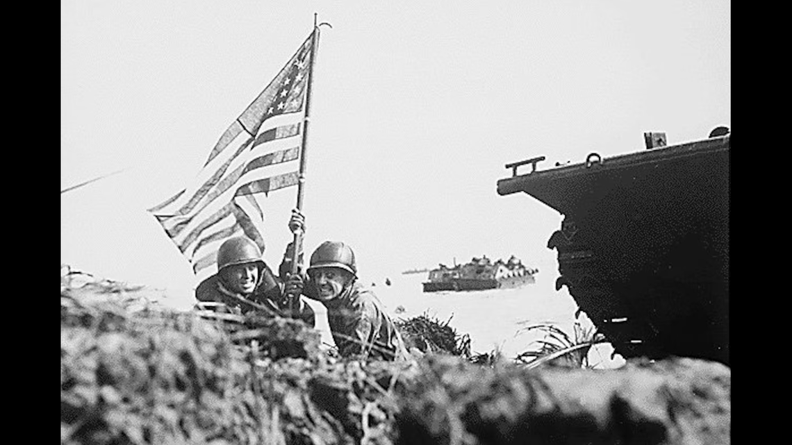 Marines plant the American flag on Guam, July 21, 1944.Photo By:Marine Corps photo