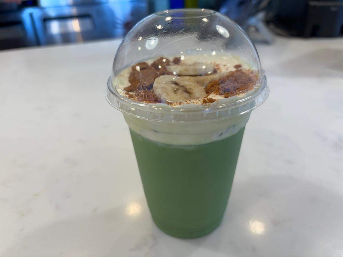 Matcha Cafe Maiko’s banana matcha latte features an earthy green tea base with strong, sweet banana-flavored milk mixed in and topped with cookie crumbles and banana slices.