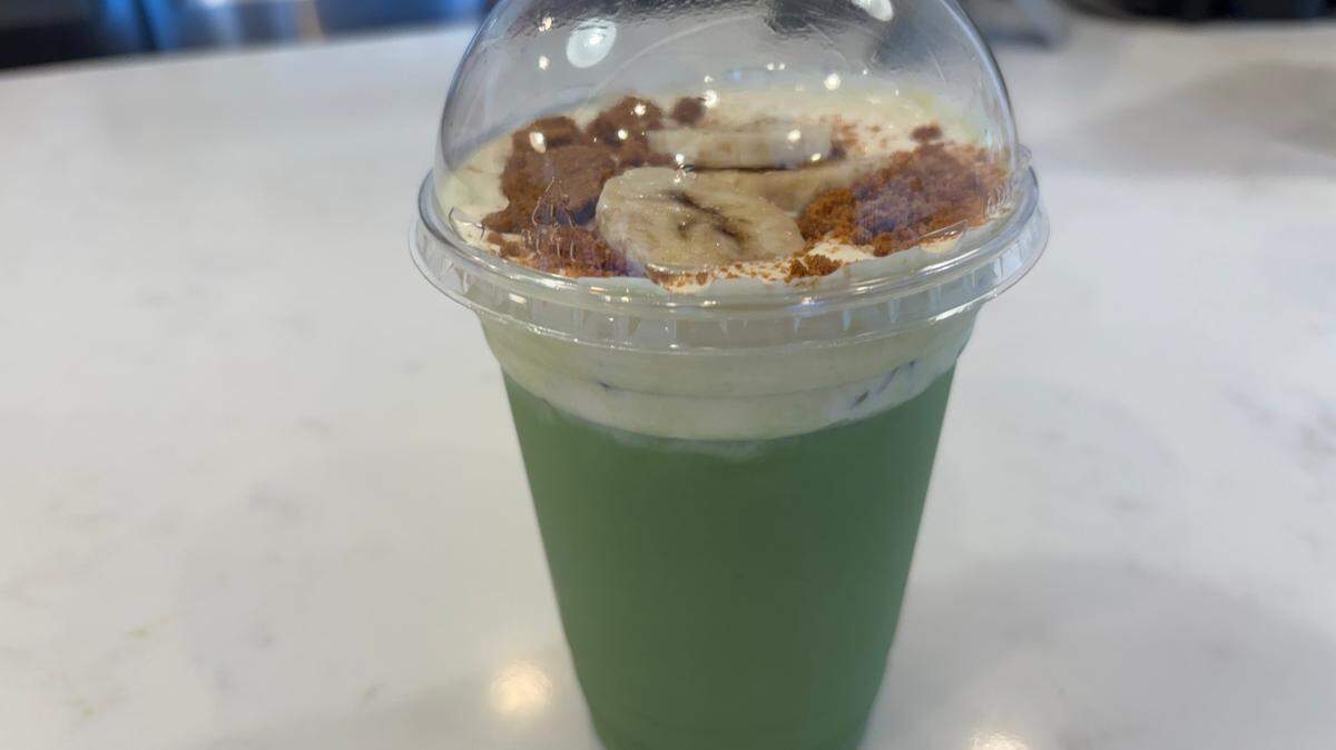 Matcha Cafe Maiko’s banana matcha latte features an earthy green tea base with strong, sweet banana-flavored milk mixed in and topped with cookie crumbles and banana slices.