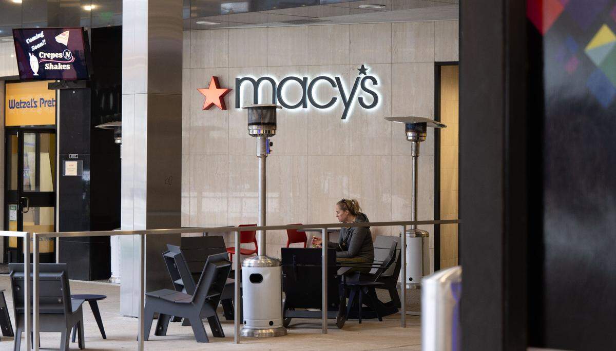 A customer sits outside the Macy’s at Downtown Commons in Sacramento in March.