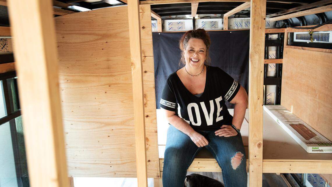 Stacy Lynn Vasquez sits in her shuttle bus which she is converting to a RV for a cross county trip after being laid-off from her job selling motor homes in Manteca. Photographed at her home in Modesto, Calif., on Wednesday, Oct. 28, 2020.