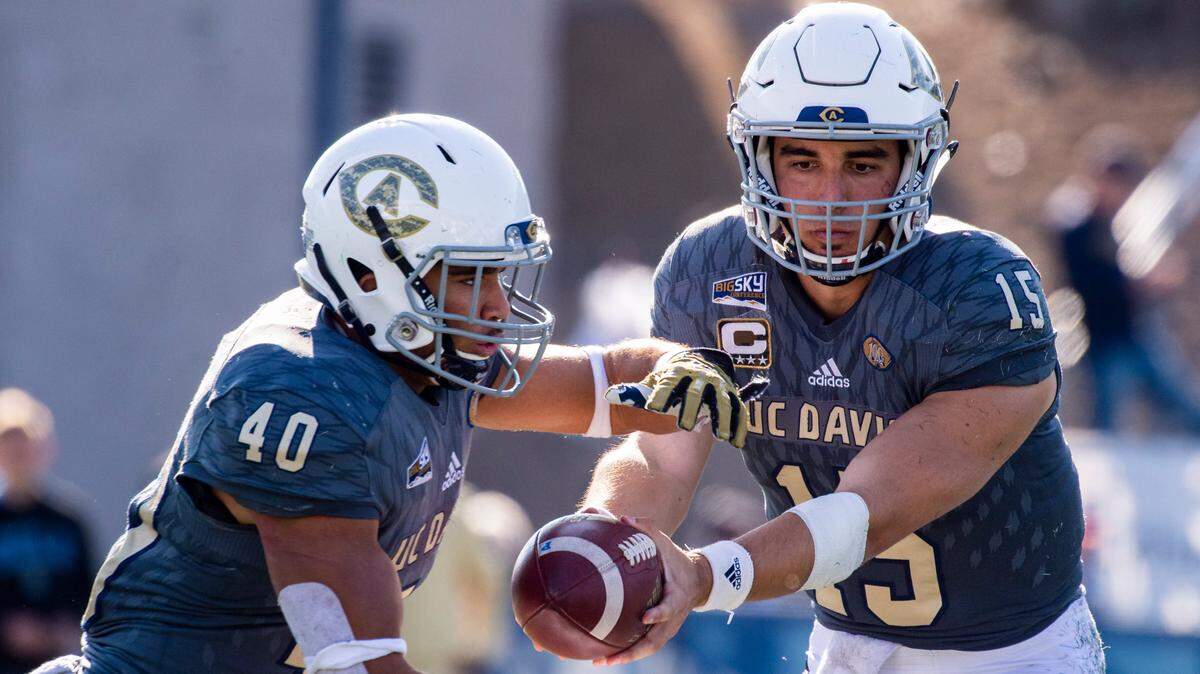 UC Davis quarterback Jake Maier (15) hands off to Ulonzo Gilliam (40) during the 65th Causeway Classic last season, when Maier was named the Big Sky Conference Offensive Player of the Year. Maier passed for 3,931 yards and 34 touchdowns.