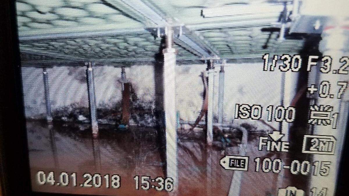 An employee takes a photo of a government camera, which documented mold issues underneath the floor of the control room in a federal prison in Mendota, California in April 2018. Employees are not permitted to take photos with their phones of the mold.