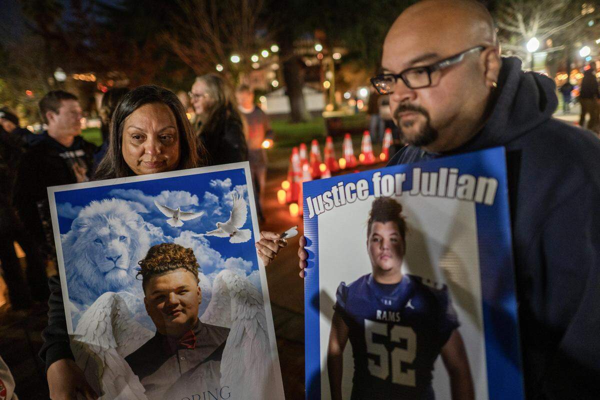 Amelia and James Snyder hold pictures of their son, Julian Gabriel Snyder, during a vigil at Fremont Park in Sacramento on Wednesday for people killed in fatal vehicle crashes. Julian died in Placer County in 2024, and his parents said they appreciated having a place to share their son's story.