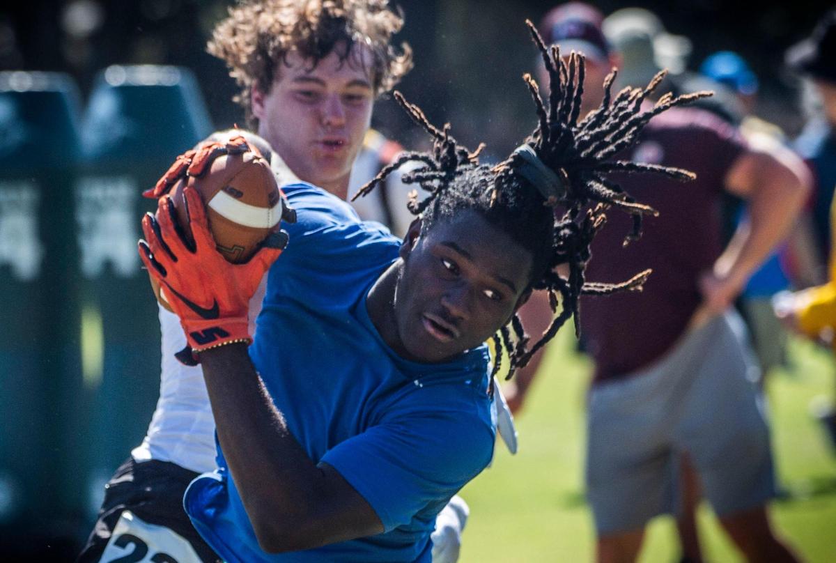 Devin Green, of Sheldon High School, catches the ball in front of Logan Studt, of Buchanan High School, during a high school football skills camp on Wednesday at Sacramento State, where players go through drills under the eye of college coaches from across the country.