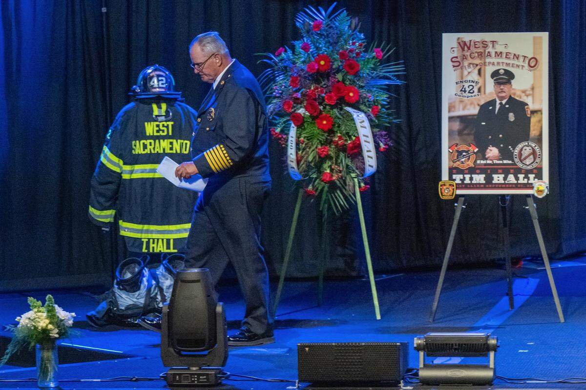 Fire Chief Steve Binns of the West Sacramento Fire Department leaves the stage after speaking at a memorial service for Fire Engineer Tim Hall at Creekside Church in Elk Grove on Tuesday.