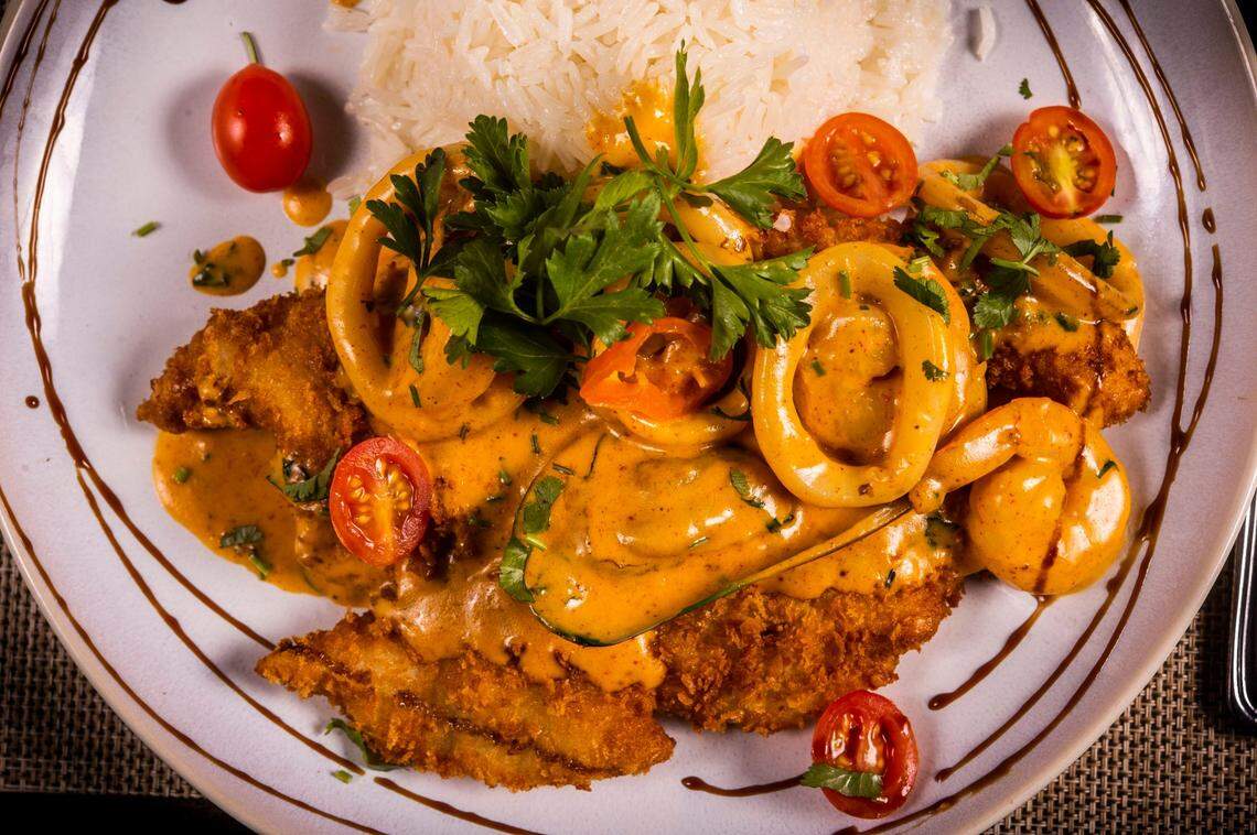 Pescado a lo Macho, a pan-fried crispy white fish fillet topped with shrimp, calamari and muscles with garlic rice is an entrée at Chicha Peruvian Kitchen in Roseville on Thursday, Feb. 10, 2022.