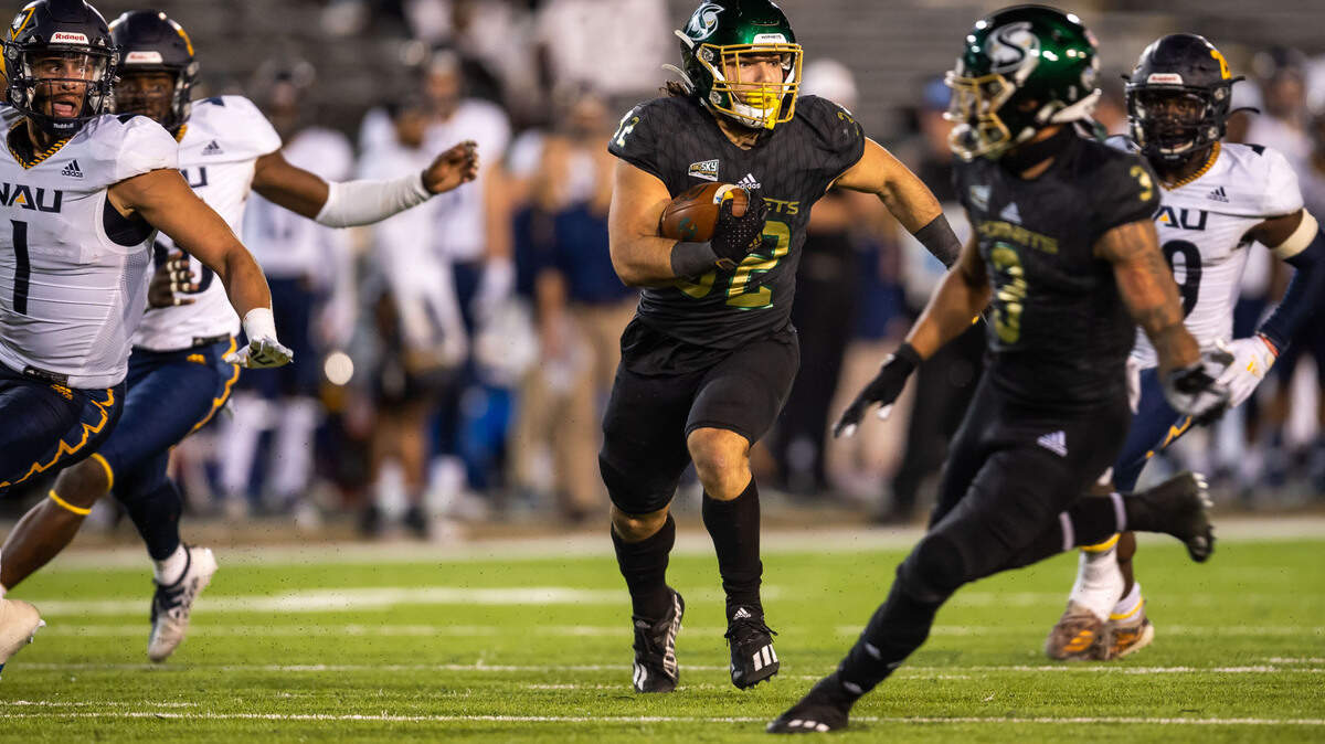Sacramento State Hornets running back Cameron Skattebo (32) runs for a gain against Northern Arizona University during the first half of the Hornets’ homecoming NCAA football game Saturday, Oct. 23, 2021, at Hornet Stadium in Sacramento.