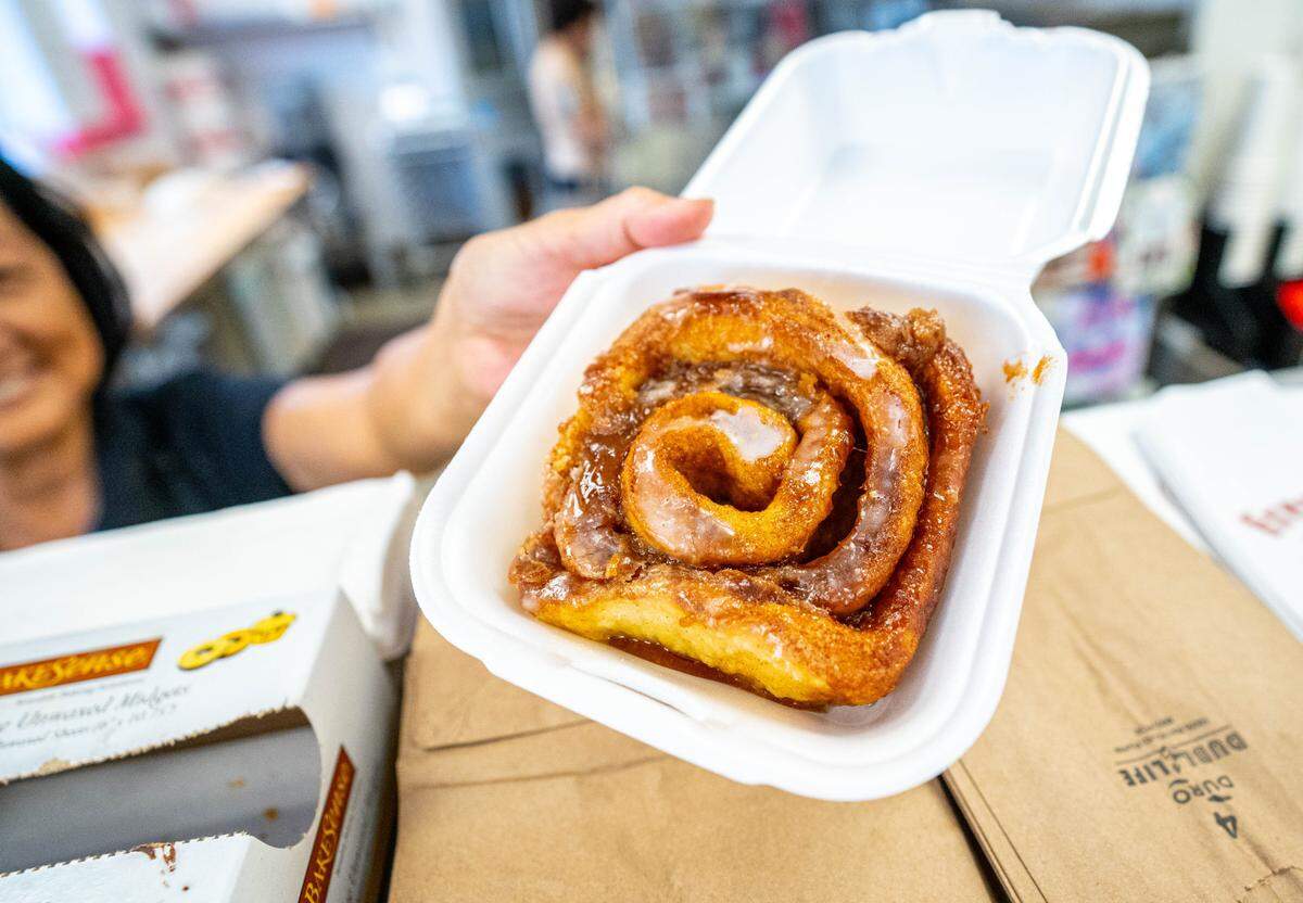 Customers looking for a Mega Millions lottery ticket make sure to grab a cinnamon bun from Spinners Cinnamon Rolls inside the 76 Gas Station in Sacramento is a Tuesday, August 1, 2023.